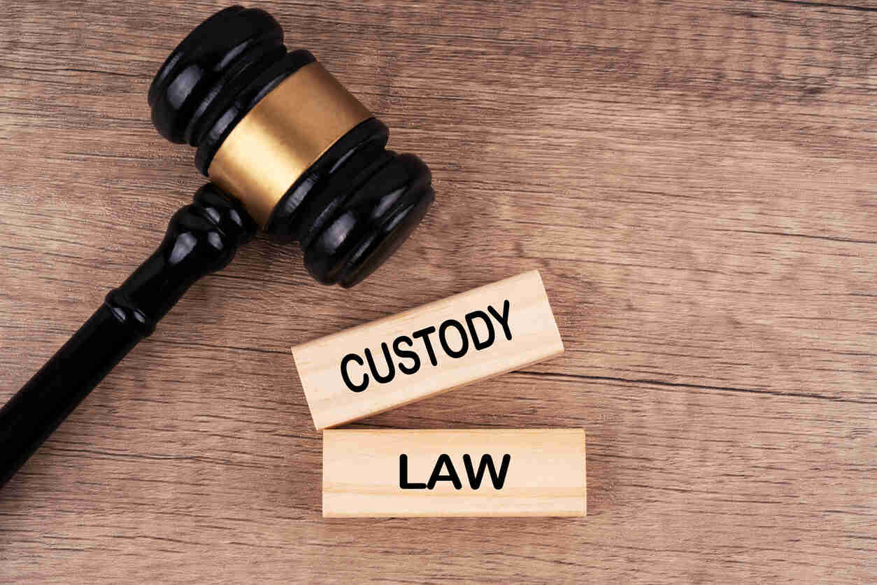A judge's gavel rests beside two wooden blocks labeled 'CUSTODY' and 'LAW', symbolizing legal decisions regarding child custody and support, particularly in high-profile California divorces.
