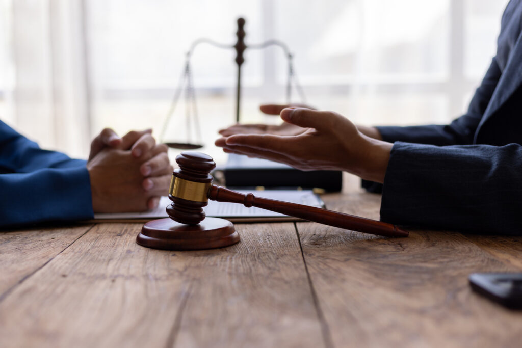 Lawyer is providing legal advice to a client. Legal advisor is discussing and explaining the terms of the legal agreement contract document before signing. Legal processing services.